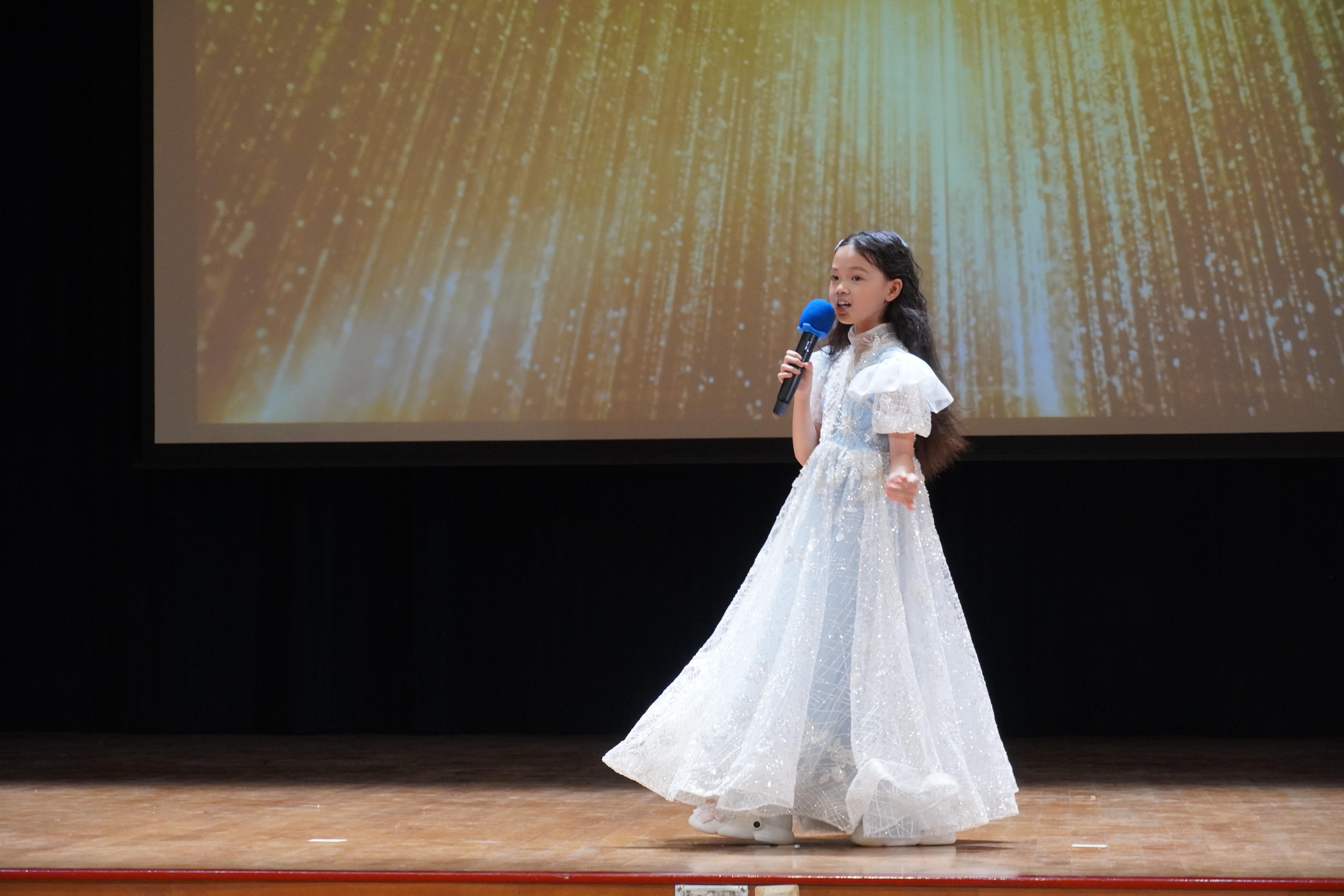 A voice ready to shine! Taking centre stage with confidence, our student shared her talent with the audience.
